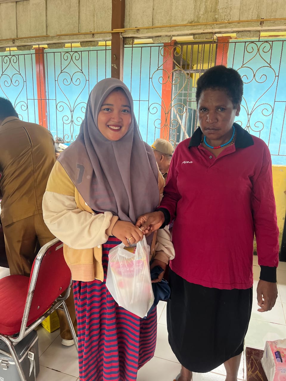 Kader posyandu memberikan makanan tambahan kepada ibu hamil