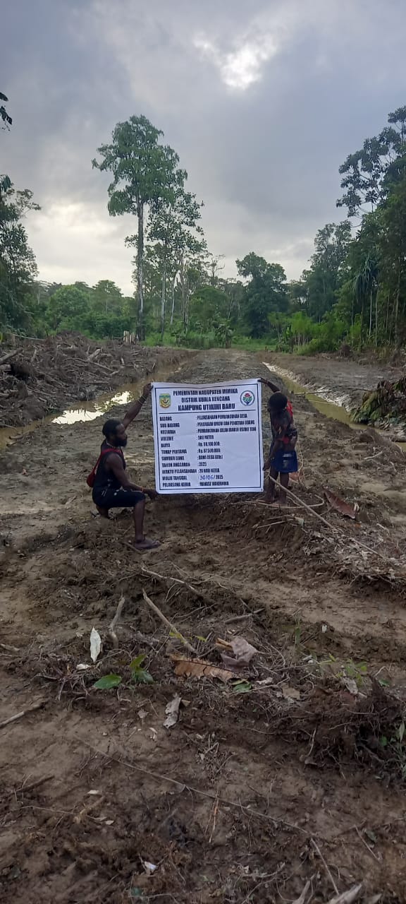 Dua orang warga sedang memegang spanduk kegiatan normalisasi sungai