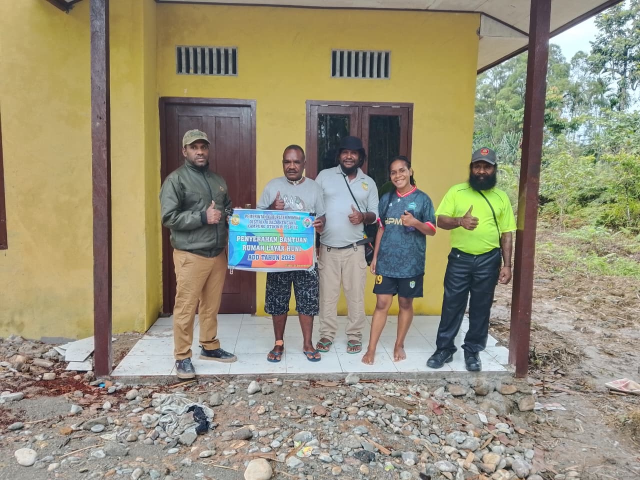 Foto bersama Kepala Kampung Utikini II, Marinus Kogoya, Sekertaris Kampung Utikini II, Naton Murib, dan warga yang menerima kunci rumah
