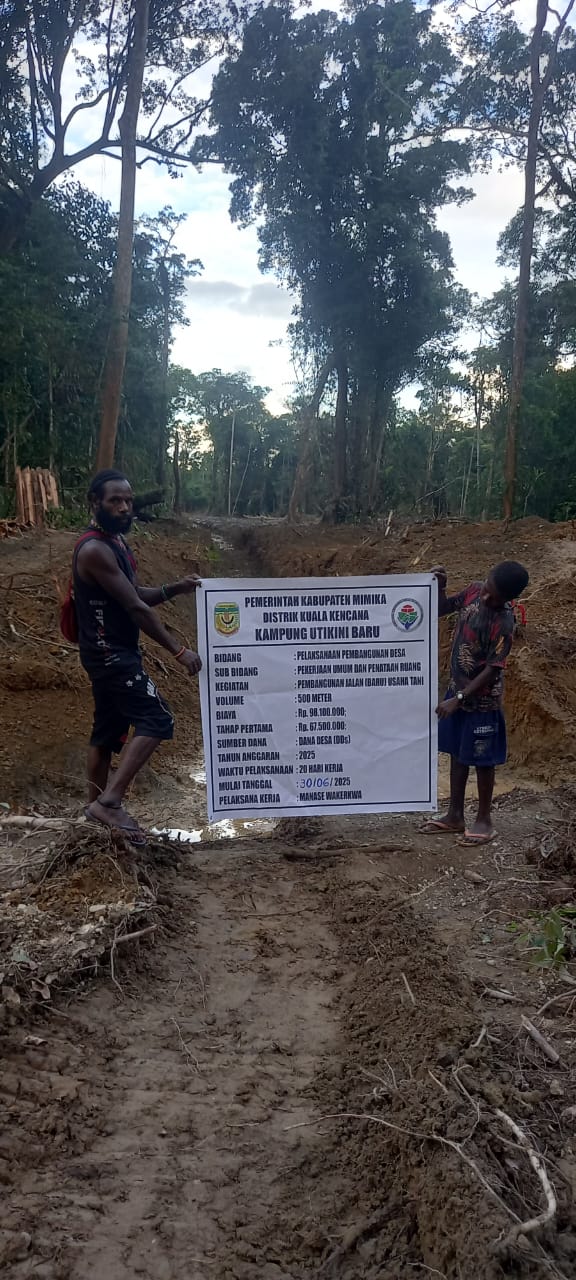 Dua orang warga sedang memegang spanduk kegiatan normalisasi sungai