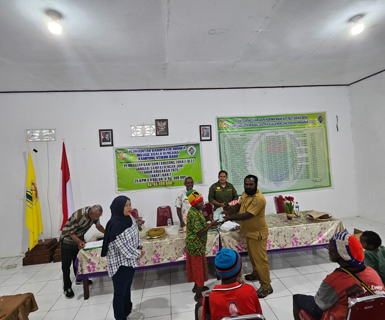 Kepala Kampung Utikini Satu, Luther Karagainal saat menyerahkan Bantuan Langsung Tunai kepada warga
