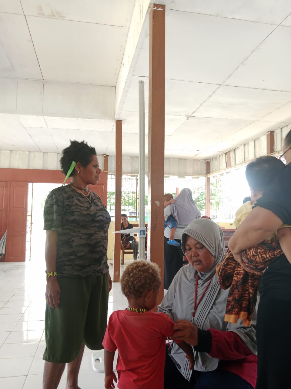 Kader posyandu dan petugas kesehatan saat mengukur tinggi badan seorang balita